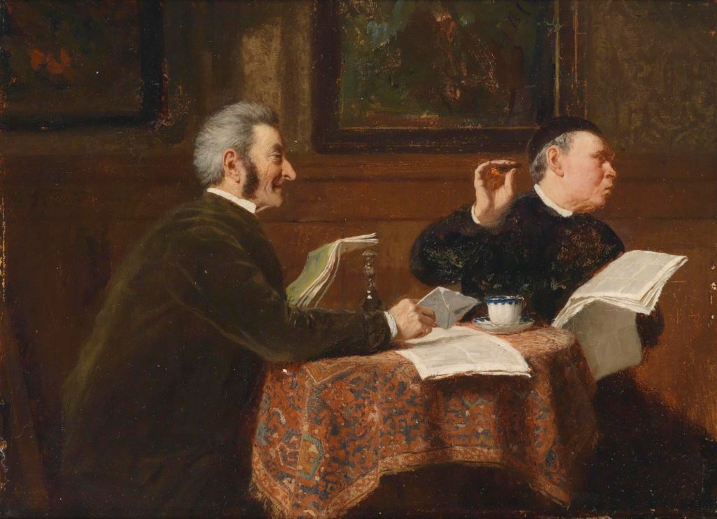 Two men seated at a table covered with a patterned tablecloth, engaged in conversation. One man, with gray hair and a beard, smiles while the other, dressed in dark clothing, appears to be dismissive. They are surrounded by framed paintings in a cozy room.